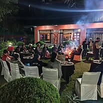 Guests seated around a bonfire outside the restaurant